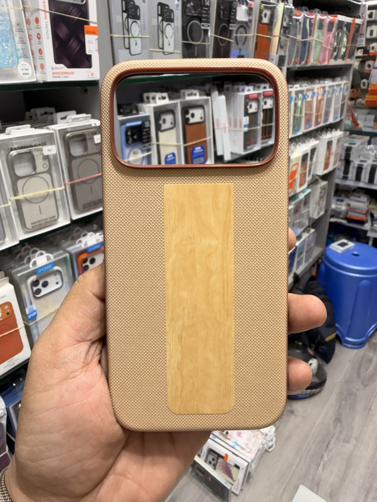 Wood panel textured MagSafe case in Beige, held in hand